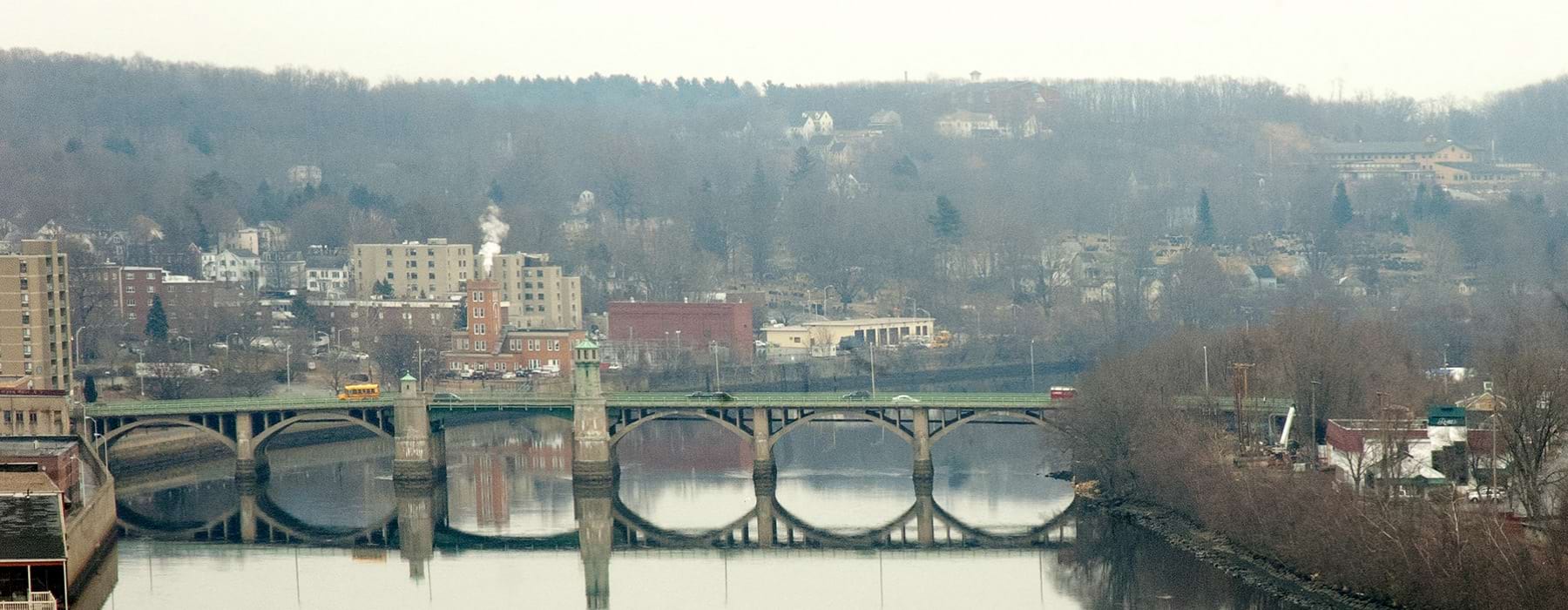 A long bridge over a still river in the downtown of Haverhill, MA
